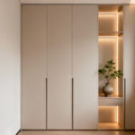 Modern floor-to-ceiling smart storage tower in a small, organized bedroom with integrated lighting and minimalist decor.